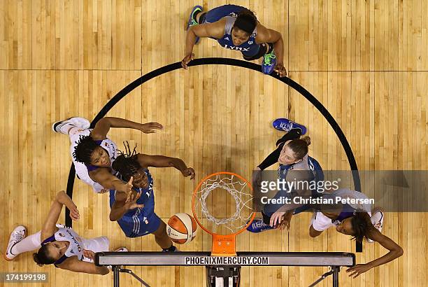 Rebekkah Brunson of the Minnesota Lynx lays up a shot under pressure from Krystal Thomas of the Phoenix Mercury during the first half of the WNBA...