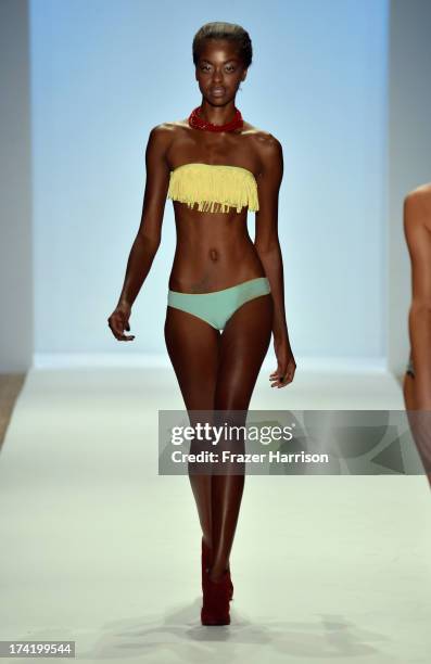 Model walks the runway at the L*Space By Monica Wise show during Mercedes-Benz Fashion Week Swim 2014 at Cabana Grande at the Raleigh on July 21,...