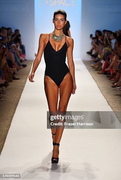 Model walks the runway at the L*Space By Monica Wise show during Mercedes-Benz Fashion Week Swim 2014 at Cabana Grande at the Raleigh on July 21,...