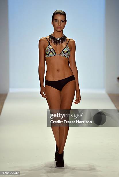 Model walks the runway at the L*Space By Monica Wise show during Mercedes-Benz Fashion Week Swim 2014 at Cabana Grande at the Raleigh on July 21,...