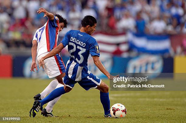 Edder Delgado of Honduras battles for the ball against Yeltsin Tejeda of Costa Rica during the 2013 CONCACAF Gold Cup quarterfinal game at M&T Bank...