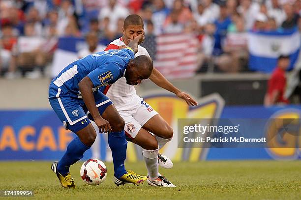 Osman Chavez of Honduras battles for the ball against Alvaro Saborio of Costa Rica during the 2013 CONCACAF Gold Cup quarterfinal game at M&T Bank...