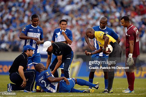 Osman Chavez of Honduras is attended to by a trainer in the first half during the 2013 CONCACAF Gold Cup quarterfinal game against Costa Rica at M&T...