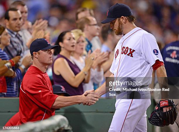 Ryan Dempster of the Boston Red Sox is congratulated by Jon Lester after being pulled from the game against the New York Yankees in the sixth inning...