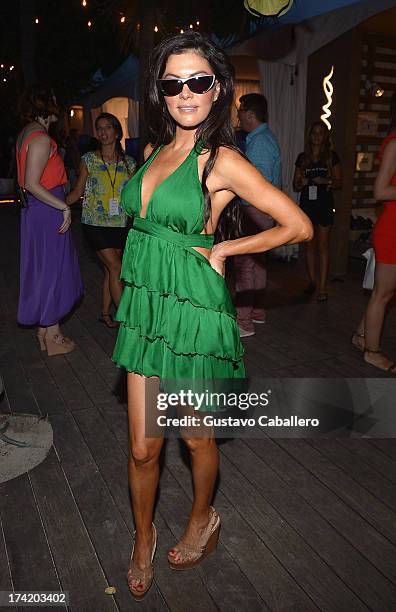 Personality Adriana DeMoura poses backstage with Ipanema at the L*SPACE By Monica Wise show during Mercedes-Benz Fashion Week Swim 2014 at Cabana...