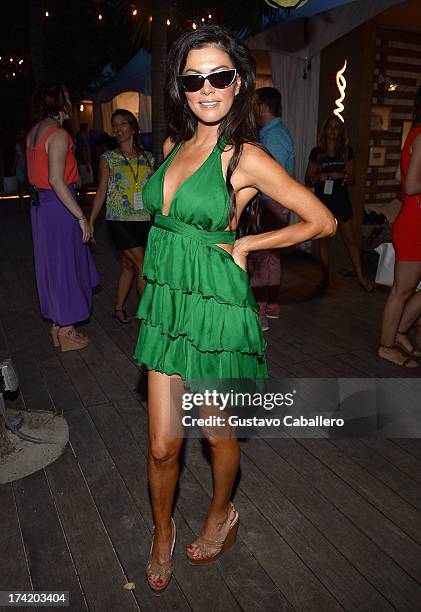 Personality Adriana DeMoura poses backstage with Ipanema at the L*SPACE By Monica Wise show during Mercedes-Benz Fashion Week Swim 2014 at Cabana...