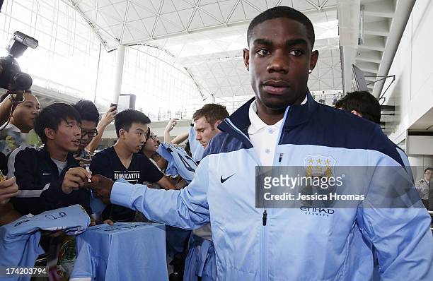 Manchester City player Micah Richards is greeted by fans at Hong Kong Airport as the team arrives to compete in the Barclays Asia Trophy, on July 22,...