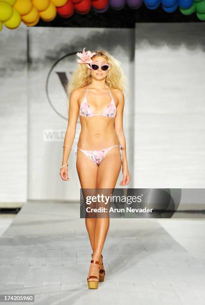 Model walks the runway at the Wildfox Swim Cruise 2014 show at Soho Beach House on July 21, 2013 in Miami Beach, Florida.