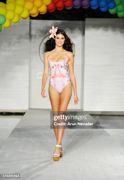 Model walks the runway at the Wildfox Swim Cruise 2014 show at Soho Beach House on July 21, 2013 in Miami Beach, Florida.