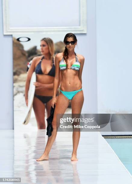 Model poses on the runway at the Oakley show during Mercedes-Benz Fashion Week Swim 2014 at the SLS Hotel on July 21, 2013 in Miami, Florida.