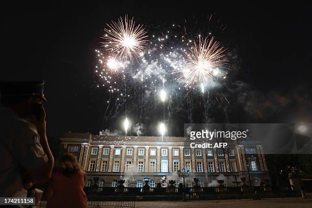 People look at fireworks late on July 21, 2013 on the Belgian National Day in the city center in Brussels. Albert II of Belgium on Sunday abdicated...