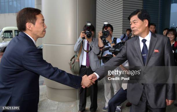 Kim Ki-Woong , the head of South Korea's working-level delegation shakes hands with his North Korean counterpart Park Chol-Su during their meeting at...