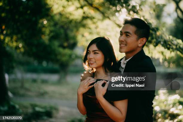 young couple in park at sunset, tokyo - falling in love stock pictures, royalty-free photos & images