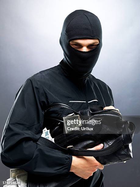making a getaway with tons of cash - balaclava headwear stock pictures, royalty-free photos & images