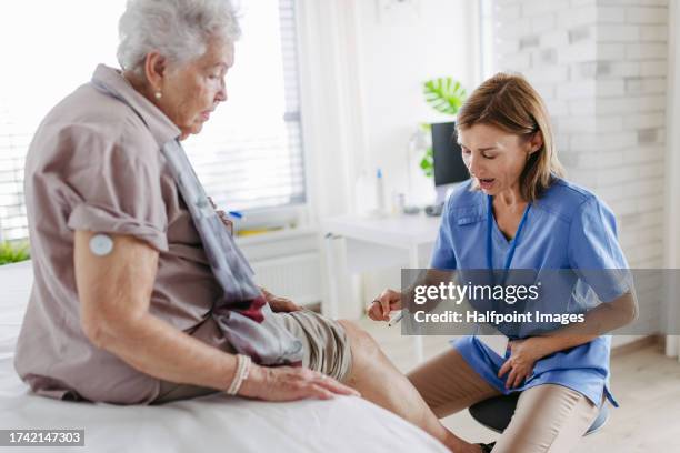 close up of doctor testing senior patient’s reflexes, using reflex hammer. - diabetes symptoms stock pictures, royalty-free photos & images