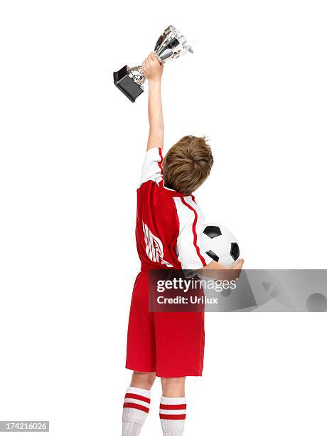 excited little boy showing his winning trophy to all - trophy stand stock pictures, royalty-free photos & images