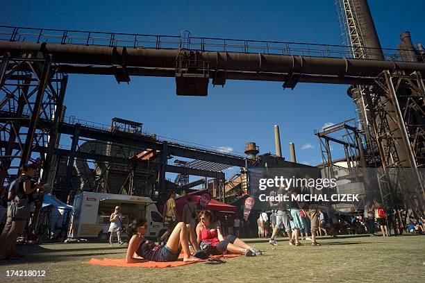 People rest on the ground of Vitkovice ironworks area during the Colours of Ostrava music festival on July 21, 2013 in Ostrava city, North Moravia....