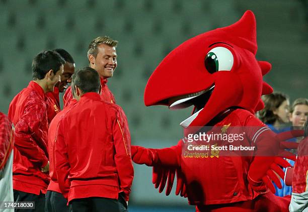 The Liverpool mascot 'Mighty Red' gestures towards Simon Mignolet, Andre Wisdom, Luis Alberto, Iago Aspas and Jay Spearing of Liverpool during a...