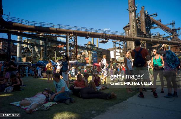 People rest on the ground of Vitkovice ironworks area during the Colours of Ostrava music festival on July 21, 2013 in Ostrava city, North Moravia....