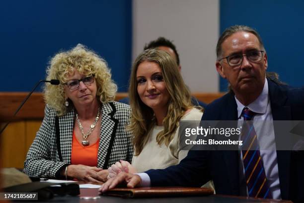 Jenna Ellis, former legal adviser to former US President Donald Trump, center, after reading a statement at the Fulton County Courthouse in Atlanta,...