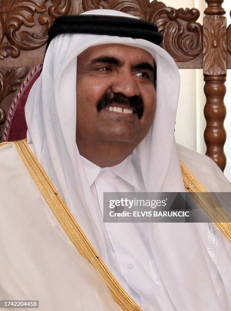 Emir of the State of Qatar Sheikh Hamad bin Khalifa Al-Thani sits with Chairman of Bosnia and Herzegovina's tripartite Presidency, Haris Silajdzic...