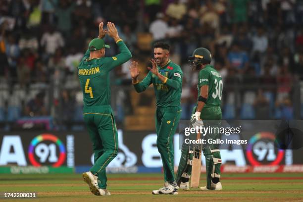 Keshav Maharaj of South Africa celebrates the wicket of Bangladesh's Mehidy Hasan Miraz during the ICC Men's Cricket World Cup 2023 match between...