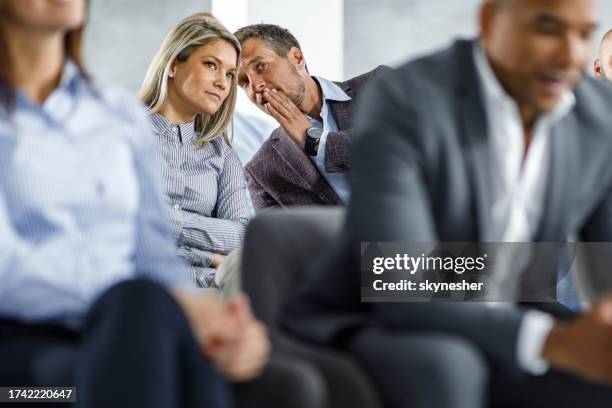 whispering on a business seminar! - gossip stock pictures, royalty-free photos & images