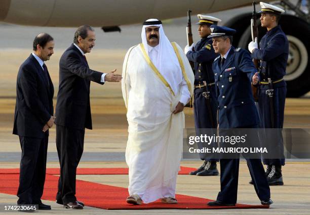 The Emir of Qatar, Hamad Bin Khalifa Al Thani , is welcomed by Brazilian officials, 09 May 2005m at Brasilia's Air Base. Al Thani arrived in the...