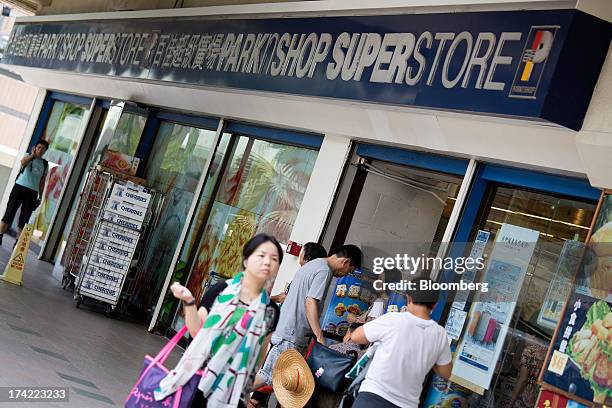 Pedestrians walk past a ParknShop superstore supermarket, operated by Hutchison Whampoa Ltd., in Hong Kong, China, on Monday, July 22, 2013....