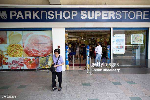 Pedestrian walks past a ParknShop superstore supermarket, operated by Hutchison Whampoa Ltd., in Hong Kong, China, on Monday, July 22, 2013....