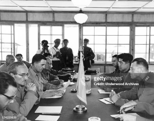 Neutral nations staff of Swiss, Swedish, Polish, and Czechoslovakian representatives meet for the first time in the building built for the signing of...