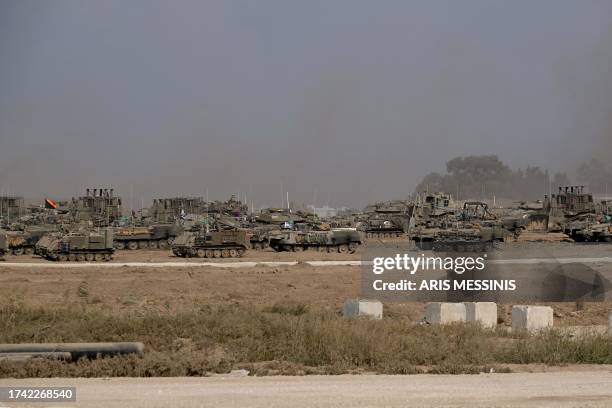 Israeli military armoured vehicles deploy along Israel's border with Gaza on October 24 amid the ongoing battles between Israel and the Palestinian...