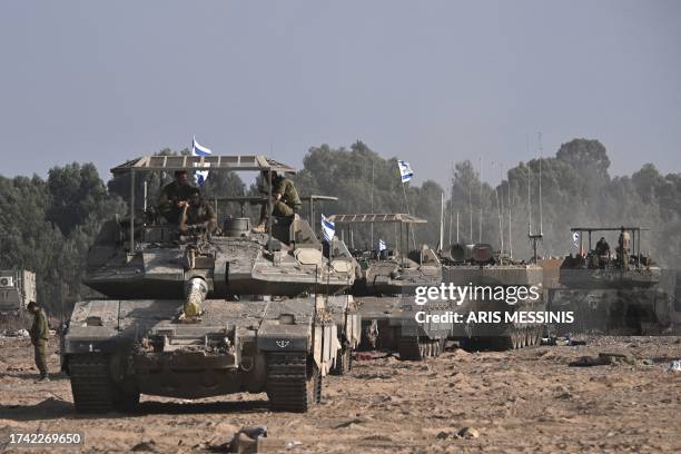 Israeli military armoured vehicles deploy along Israel's border with Gaza on October 24 amid the ongoing battles between Israel and the Palestinian...