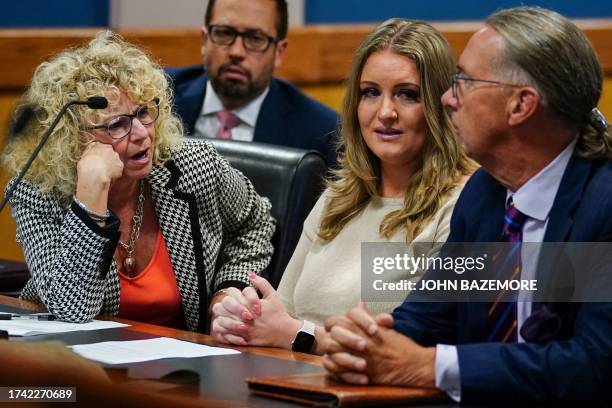 Jenna Ellis reacts with her lawyers after reading a statement pleading guilty to one felony count of aiding and abetting false statements and...