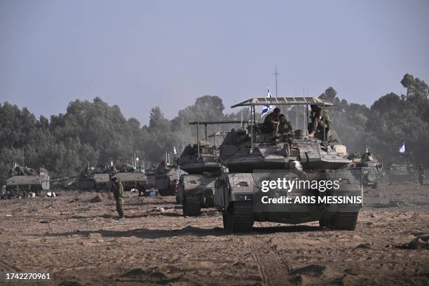 Israeli military armoured vehicles and tanks deploy along Israel's border with Gaza on October 24 amid the ongoing battles between Israel and the...