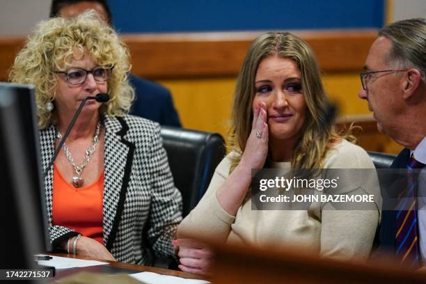 Jenna Ellis reacts with her lawyers after reading a statement pleading guilty to one felony count of aiding and abetting false statements and...