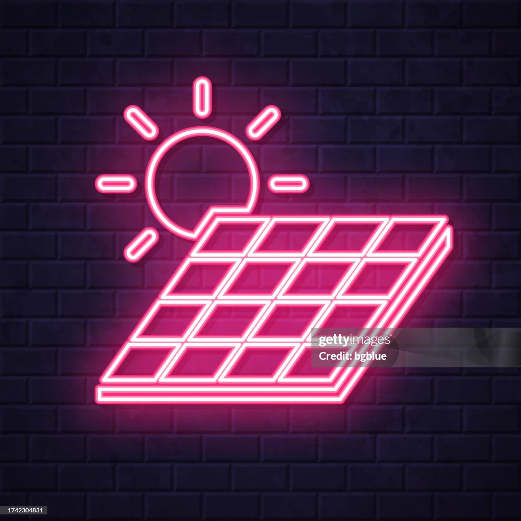 Solar panel with sun. Glowing neon icon on brick wall background
