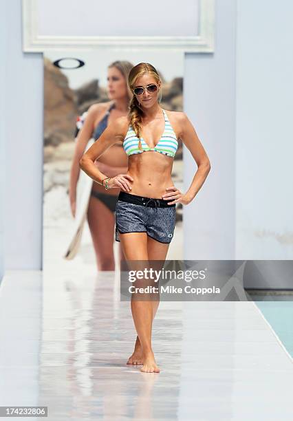 Model walks the runway at the Oakley show during Mercedes-Benz Fashion Week Swim 2014 at the Raleigh on July 21, 2013 in Miami Beach, Florida.