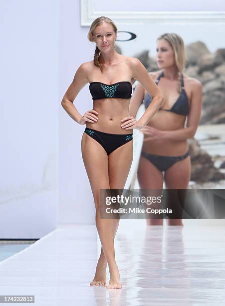 Model walks the runway at the Oakley show during Mercedes-Benz Fashion Week Swim 2014 at the Raleigh on July 21, 2013 in Miami Beach, Florida.