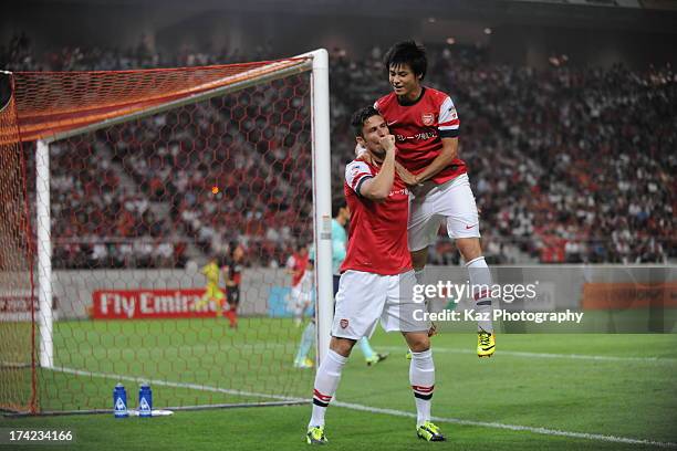 Olivier Giroud of Arsenal celebrates with Ryo Miyaichi of Arsenal after his opener during the pre-season friendly match between Nagoya Grampus and...