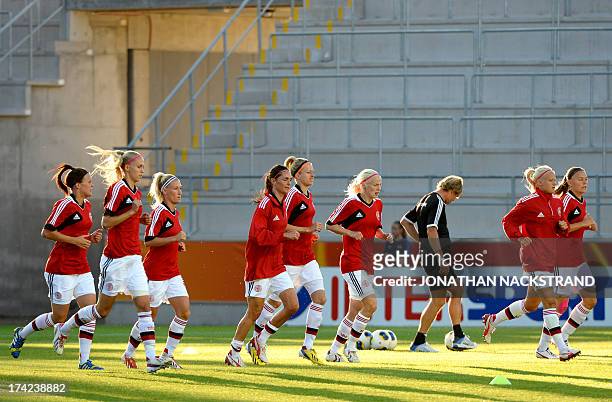 Denmark's players warm up prior to the UEFA Women's European Championship Euro 2013 quarter final football match France vs Denmark on July 22, 2013...