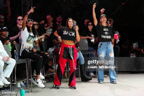 Ja Wilson, Kelsey Plum, and Alysha Clark of the Las Vegas Aces celebrate during the 2023 WNBA championship victory parade and rally on the Las Vegas...