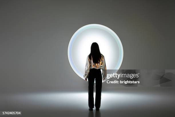 young woman in front of a circular light shape - modeling and simulation stock pictures, royalty-free photos & images
