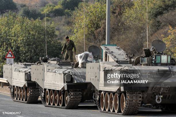 Israeli army tracked vehicles are deployed at a position in the Upper Galilee region in northern Israel near the border with southern Lebanon on...