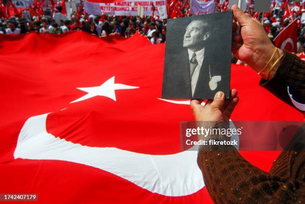 the turkish flag raised by the crowd in the square and a portrait photo of ataturk - mustafa kemal ataturk stock pictures, royalty-free photos & images