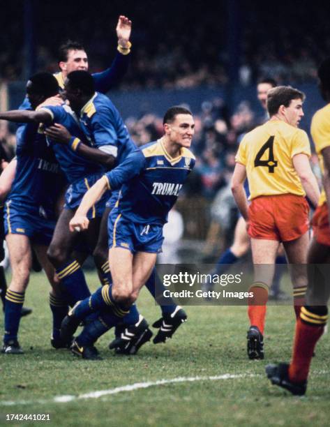 Wimbledon players Eric Young Andy Thorn John Fashanu and Vinnie Jones celebrate the winning goal as Kenny Jackett of Watford looks on during the FA...