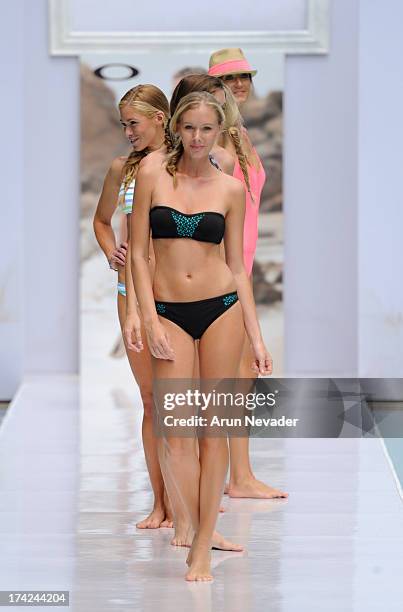 Models walk the runway during the Oakley fashion show at Mercedes-Benz Fashion Week Swim 2014 - Runway at the SLS Hotel on July 21, 2013 in Miami,...