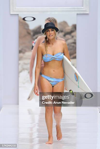 Model walks the runway during the Oakley fashion show at Mercedes-Benz Fashion Week Swim 2014 - Runway at the SLS Hotel on July 21, 2013 in Miami,...