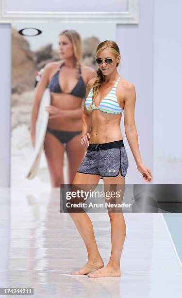 Model walks the runway during the Oakley fashion show at Mercedes-Benz Fashion Week Swim 2014 - Runway at the SLS Hotel on July 21, 2013 in Miami,...
