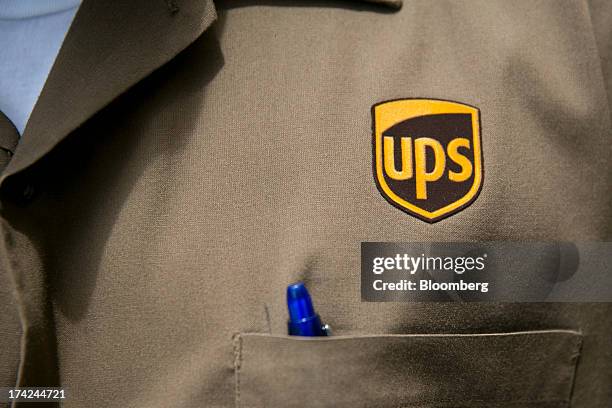 The United Parcel Service Inc. Logo is seen on the shirt of employee Mike Hill in this arranged photo in Washington, D.C., U.S., on Monday, July 22,...
